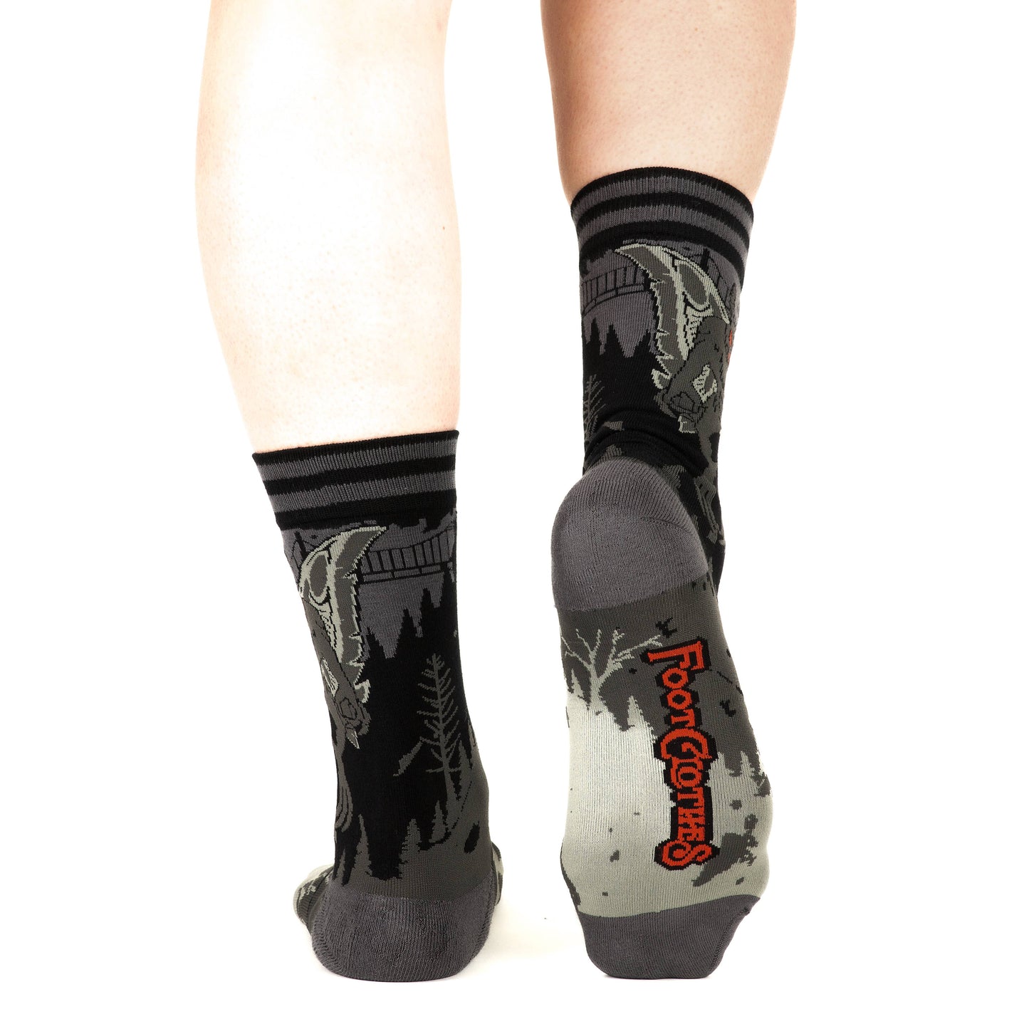 Model wearing a pair of socks featuring Mothman. Grey legs, grey heel, toe and cuff.
