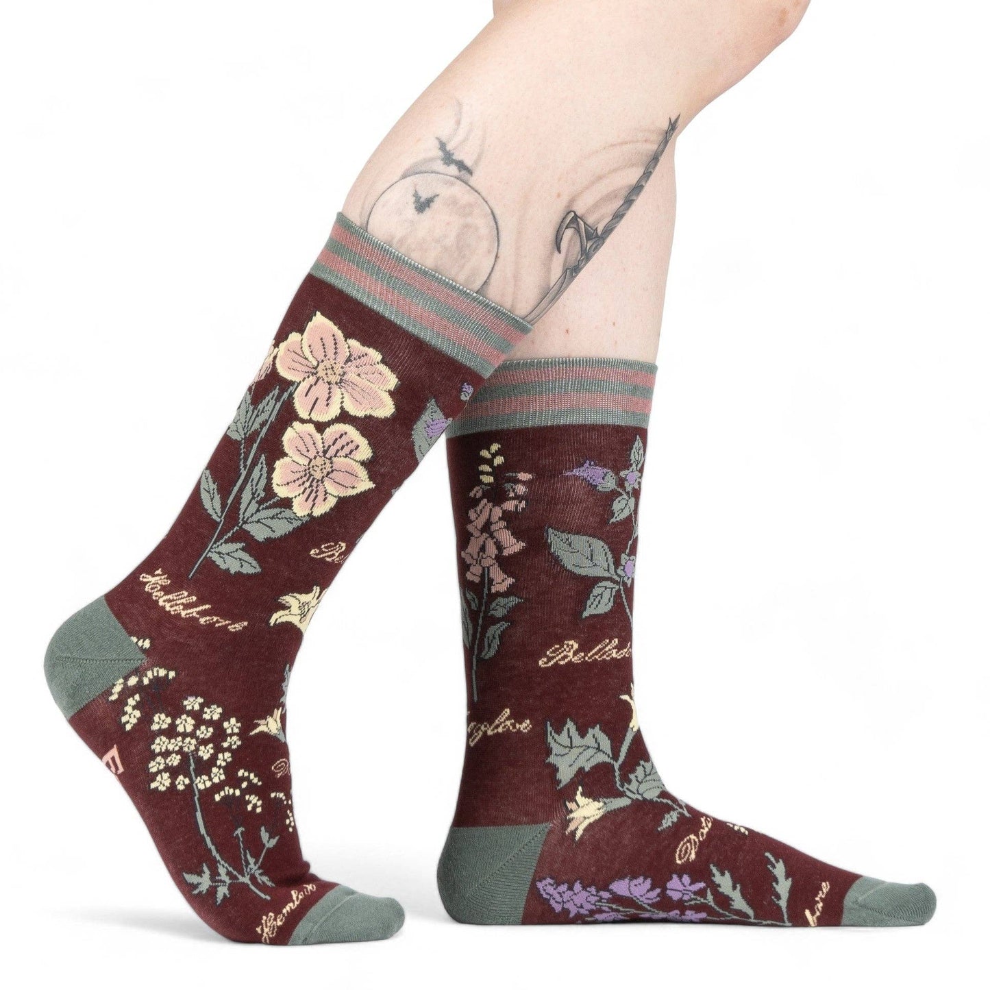 Baneful Botany Crew Socks. A pair of socks with a botany motif. Brown legs, green heel, toe and cuff.