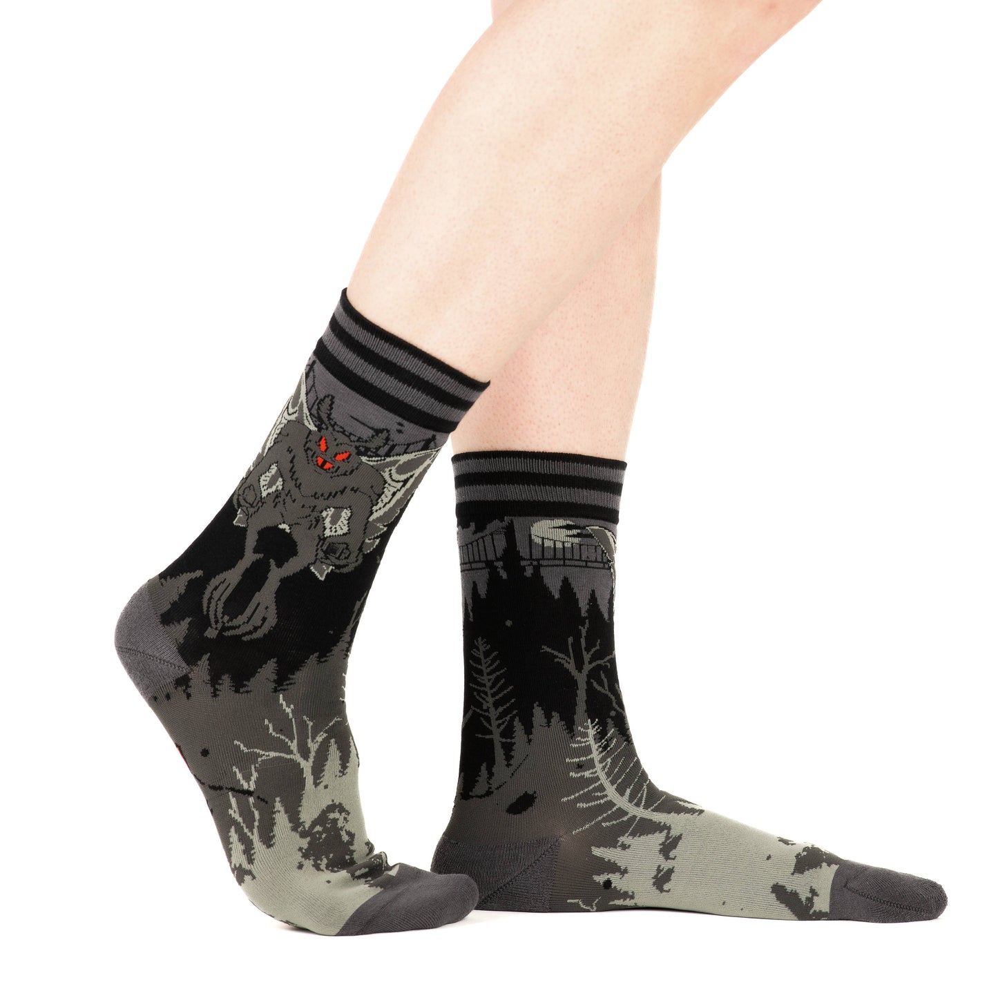 Model wearing a pair of socks featuring Mothman. Grey legs, grey heel, toe and cuff.