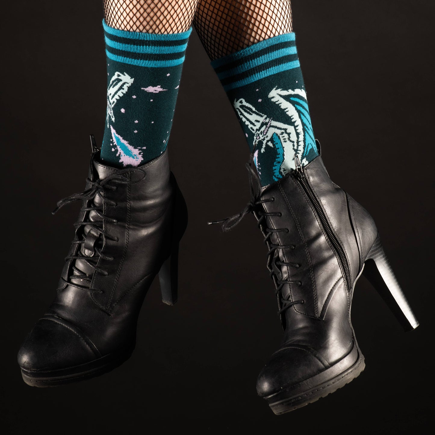 Model wearing a of socks featuring an evil dragon. Blue legs, green heel, toe and cuff.
