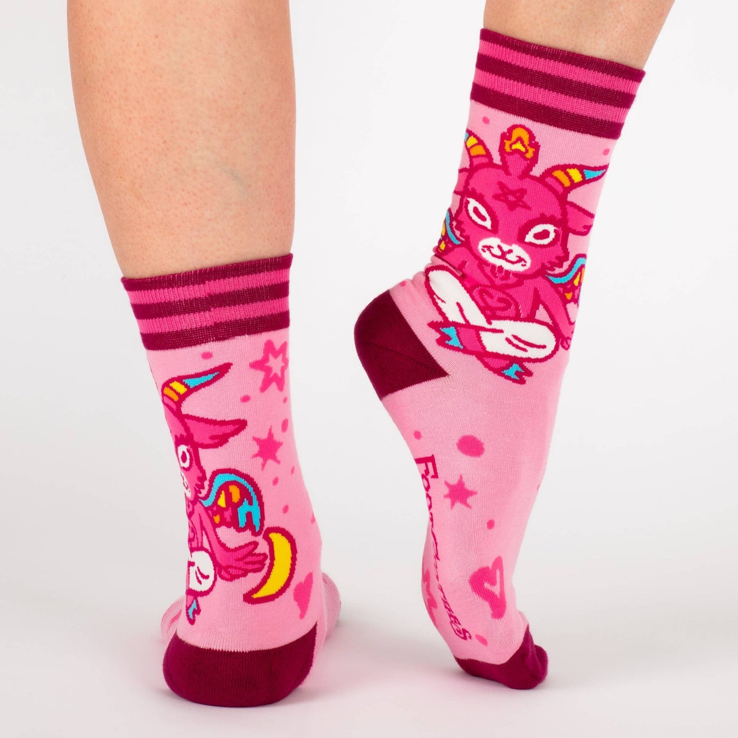A pair of socks featuring a cute little devil. Pink legs, bright pink heel, toe and cuff.