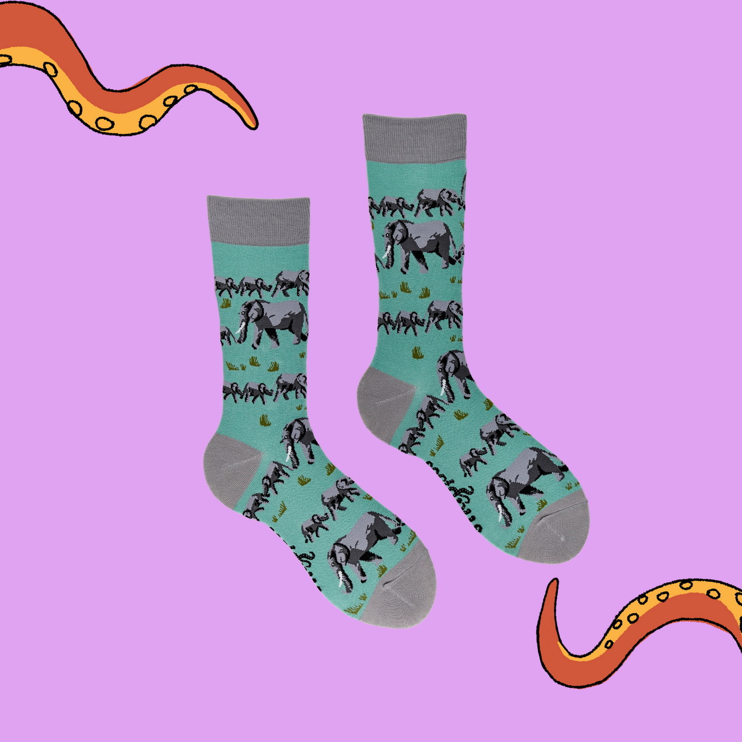 A pair of socks depicting elephants. Turquoise legs, grey cuff, heel and toe.