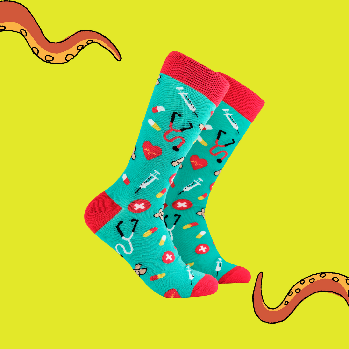 A pair of socks depicting medical equipment and symbols. Green legs, red cuff, heel and toe.
