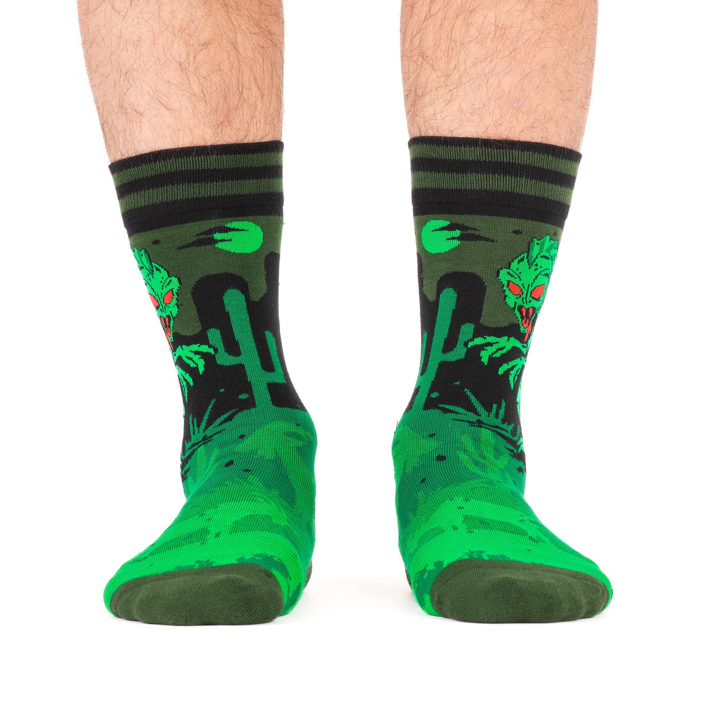 A model wearing a pair of socks featuring El Chupacabra. Green legs, heel, toe and cuff.