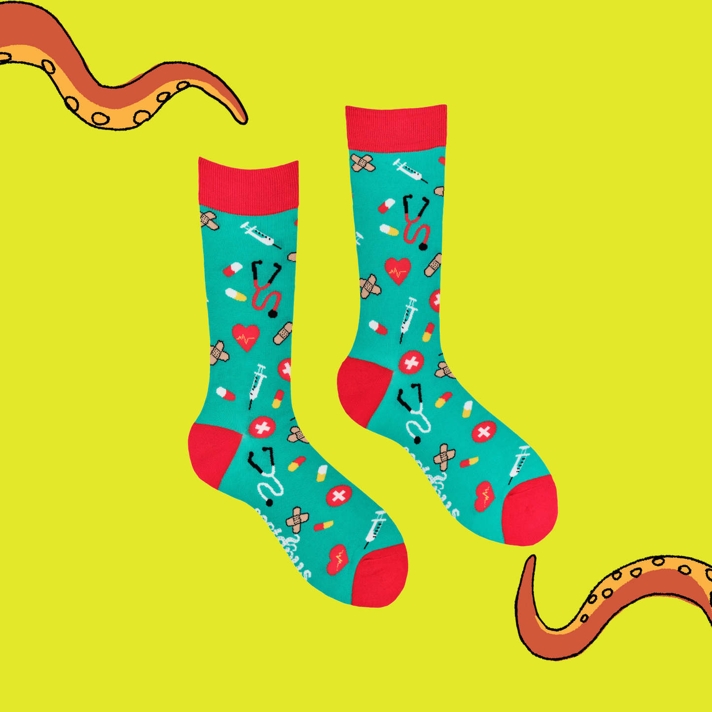 A pair of socks depicting medical equipment and symbols. Green legs, red cuff, heel and toe.