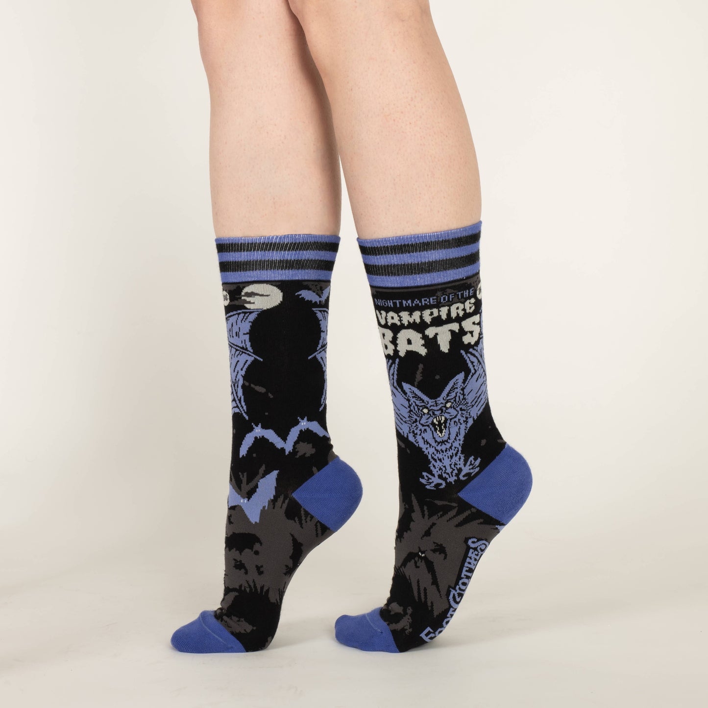 A pair of socks depicting a scary looking vampire bat. Blue toes, cuff and heel.
