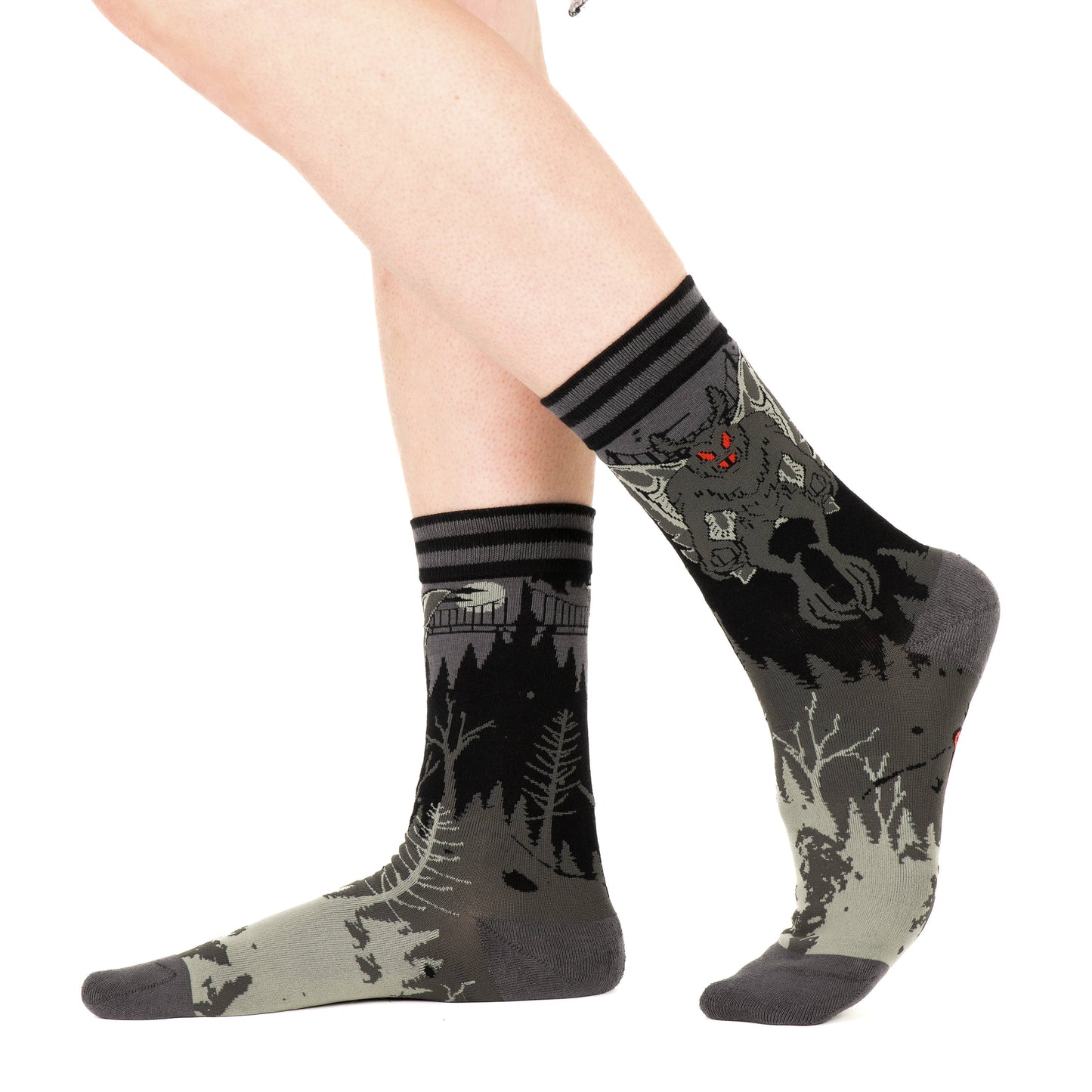 Model wearing a pair of socks featuring Mothman. Grey legs, grey heel, toe and cuff.