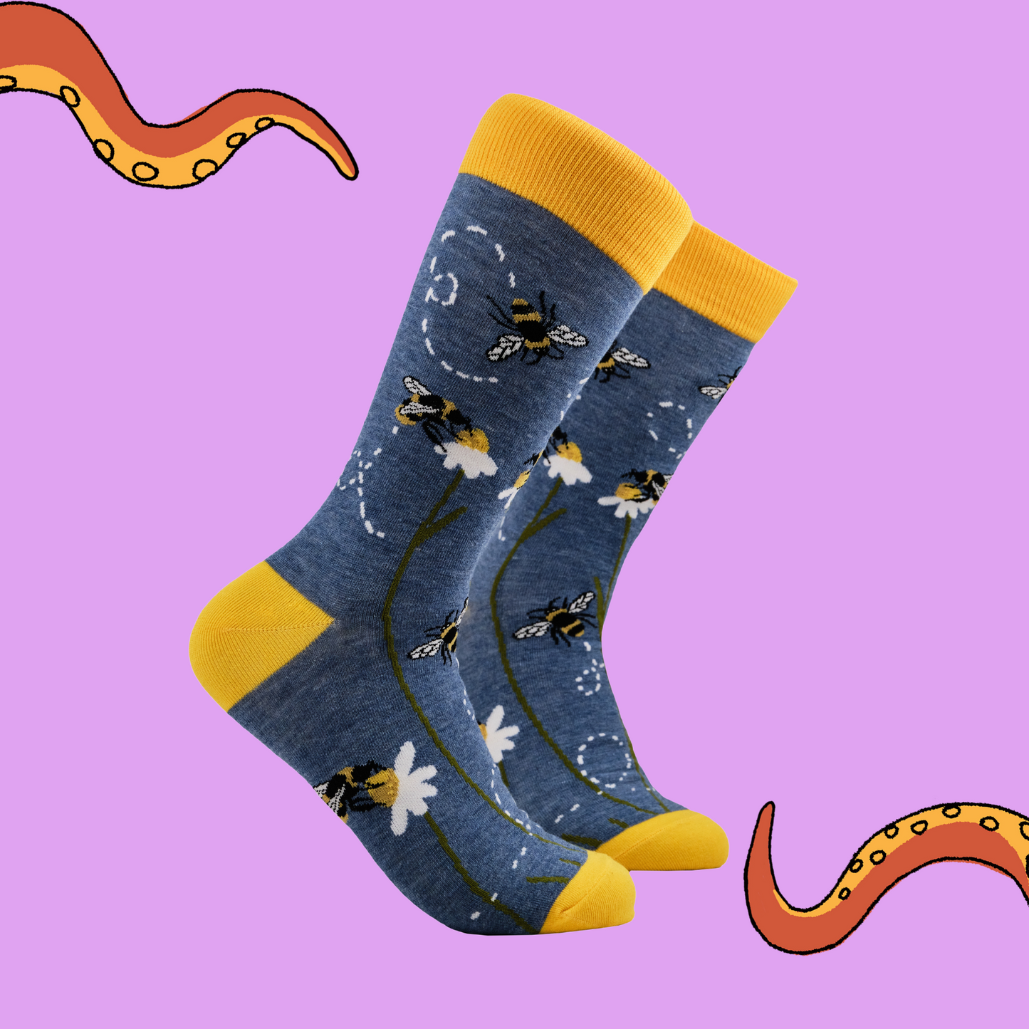 A pair of socks with a bee and daisy motif. Blue legs, yellow heel, toe and cuff.