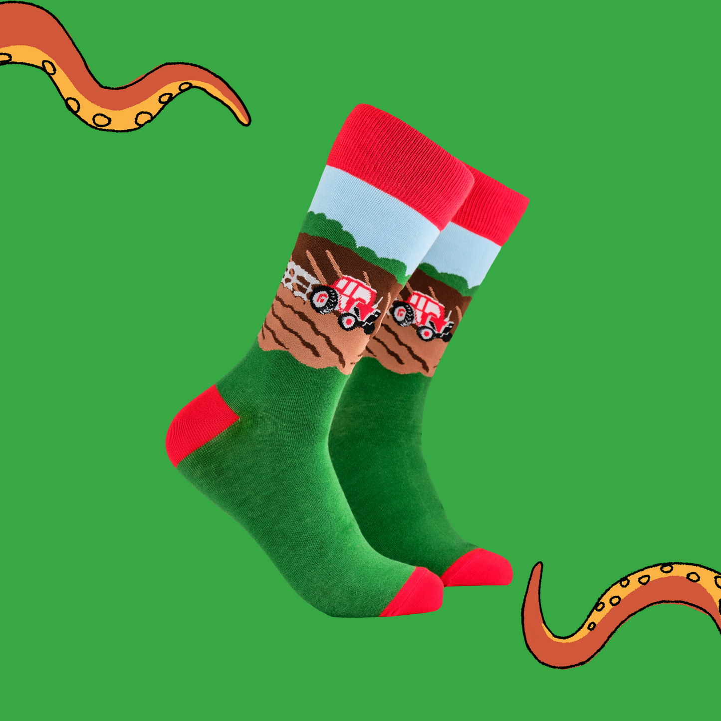A pair of socks depicting farm life and tractor plowing the field.. Green legs, red cuff, heel and toe.
