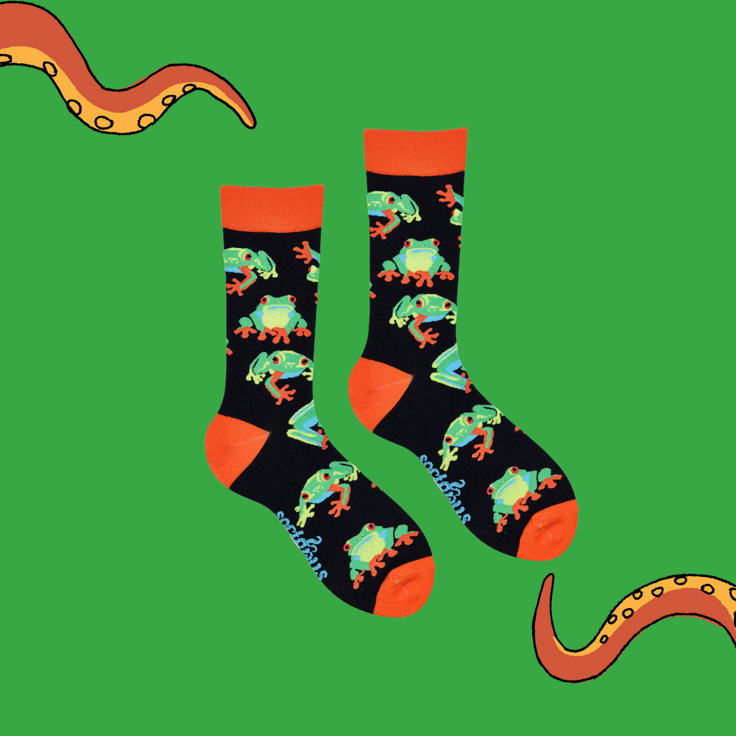 A pair of socks depicting tree frogs. Black legs, orange cuff, heel and toe.