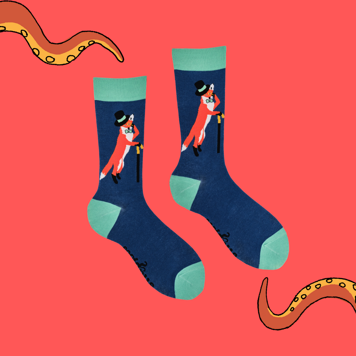 A pair of socks depicting a fox in a top hat and monocle. Blue legs, green cuff, heel and toe.