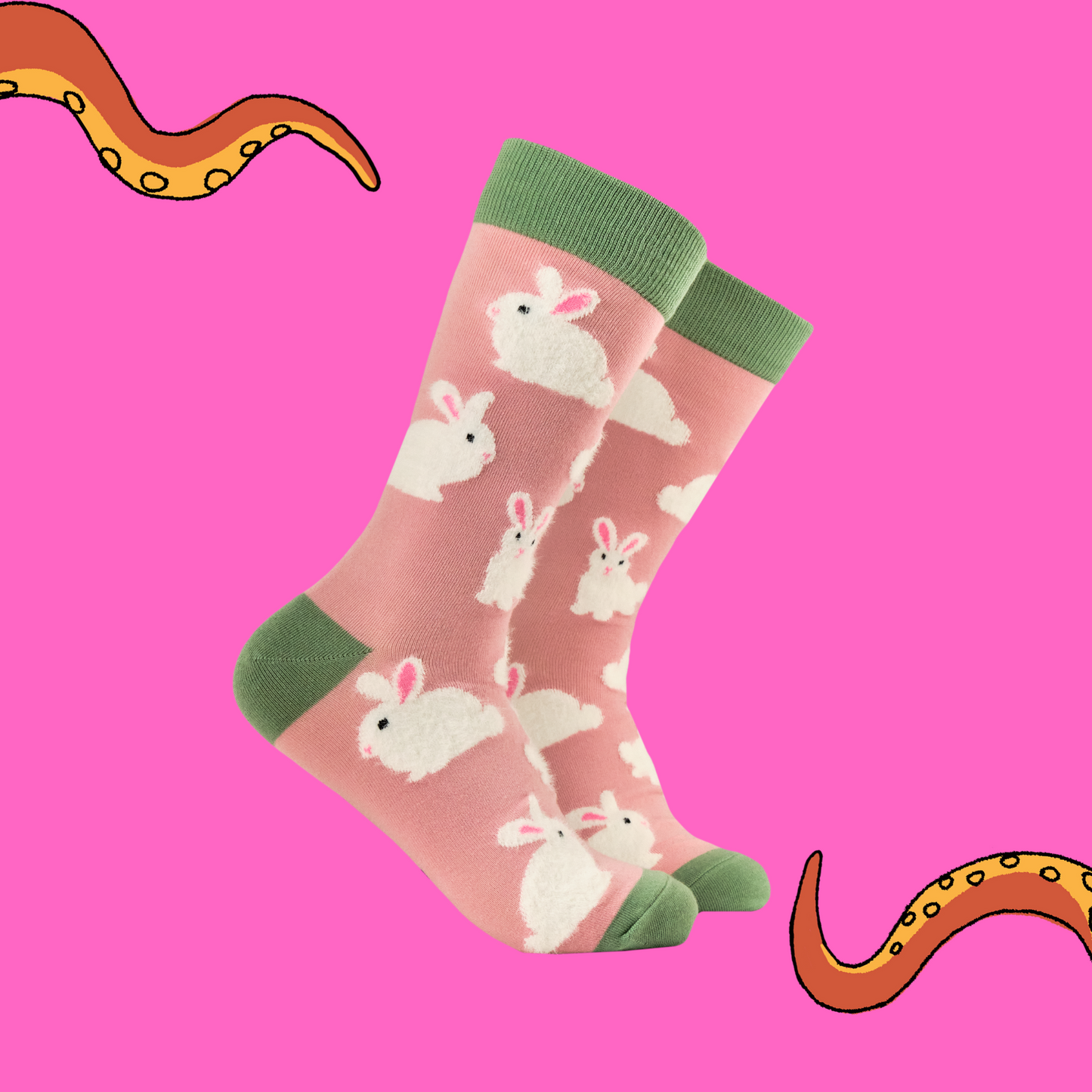 A pair of socks that feature fluffy bunnies. Pink legs, green, heel, toe and cuff.