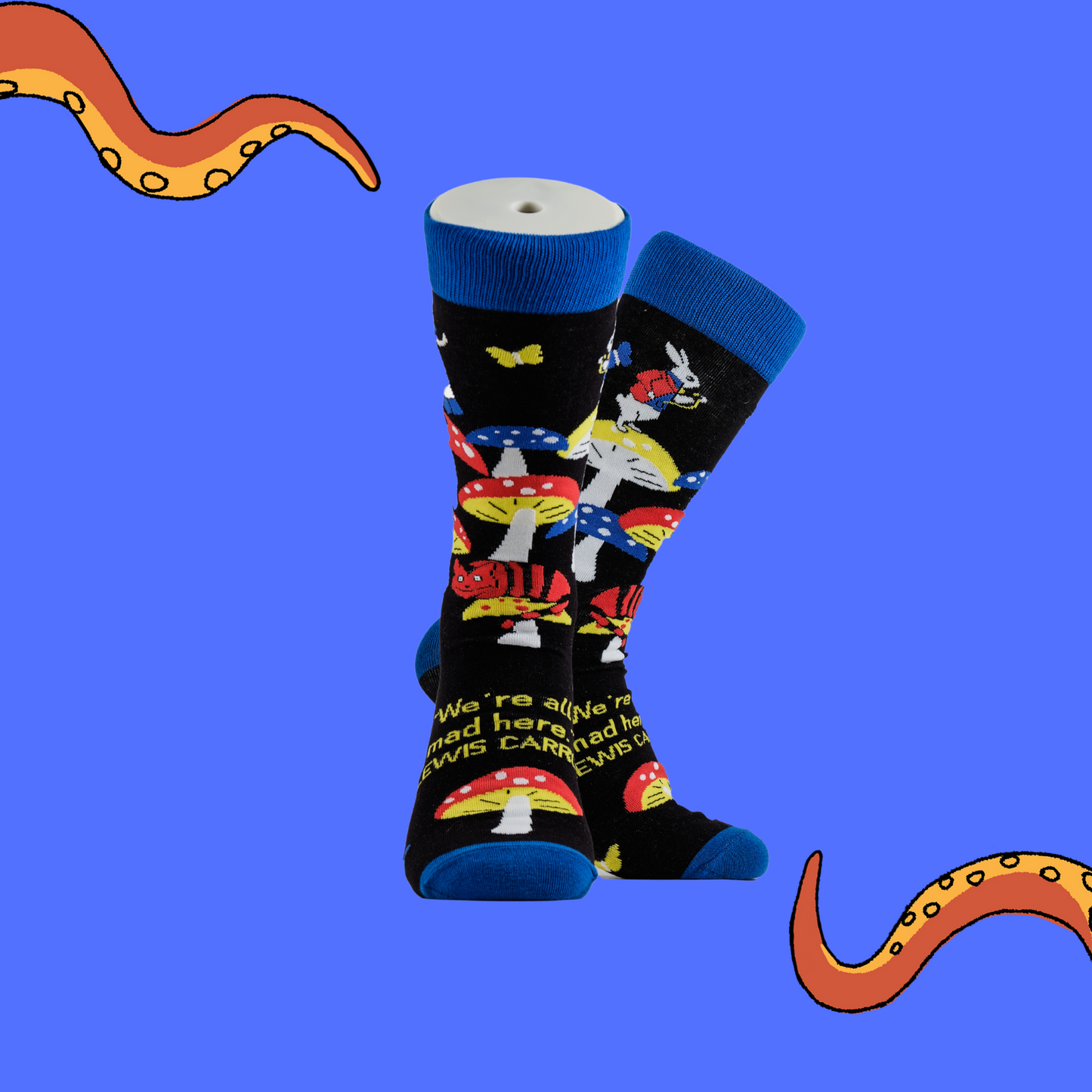 A pair of socks depicting Alice in wonderland and toadstools. Black legs, royal blue cuff, heel and toe.