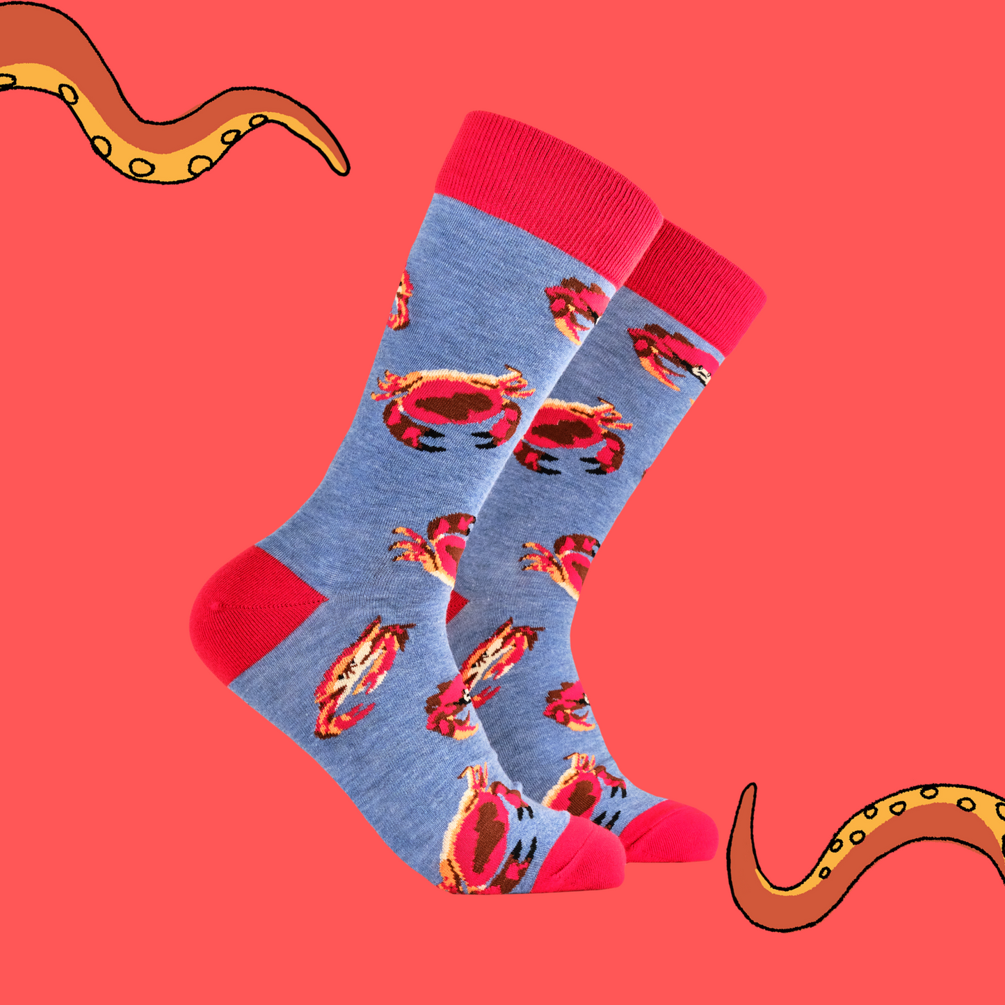 A pair of socks featuring a crab motif. Blue legs, red heel, toe and cuff.