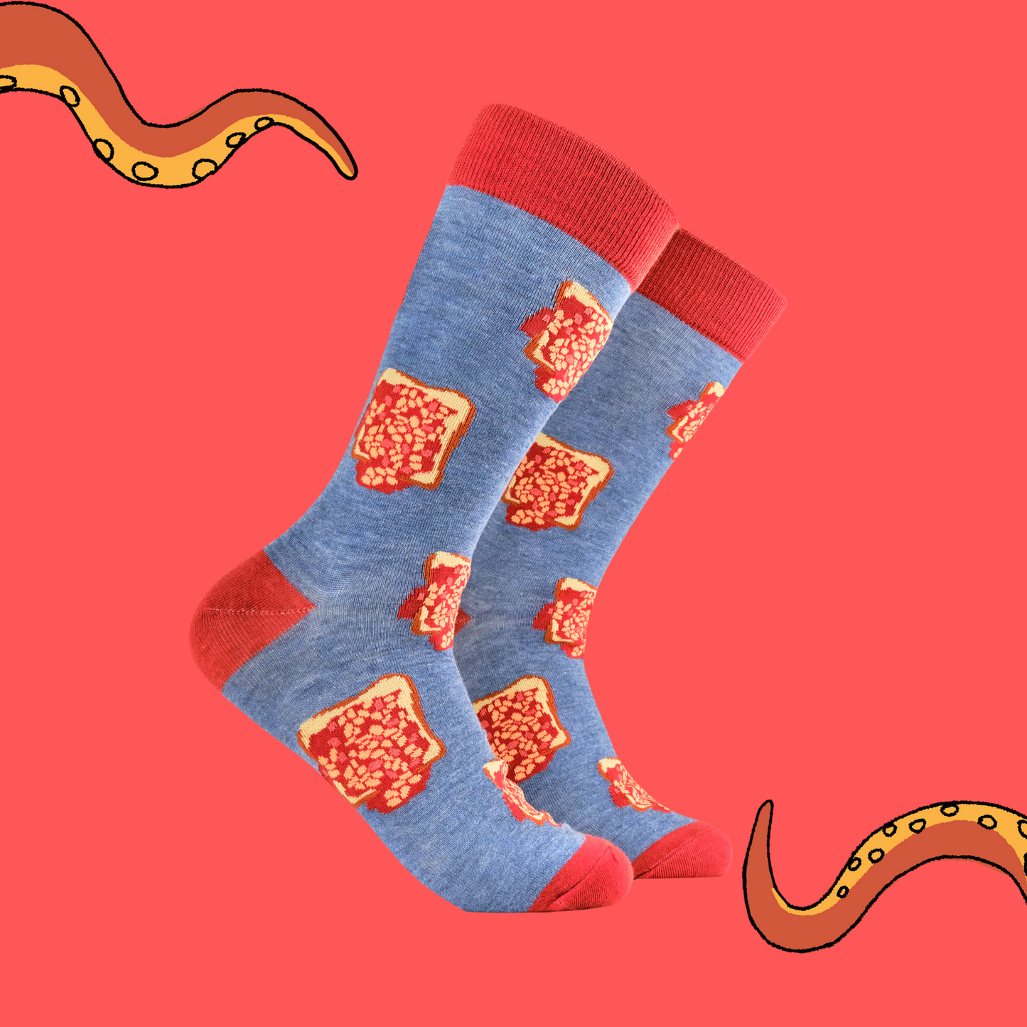 A pair of socks depicting beans on toast. Blue legs, red heel, toe and cuff.