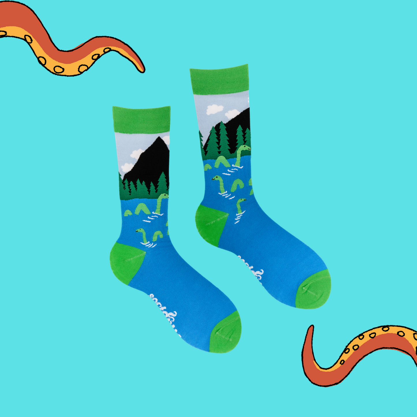 A pair of socks depicting the loch ness monster. Blue legs, green cuff, heel and toe.
