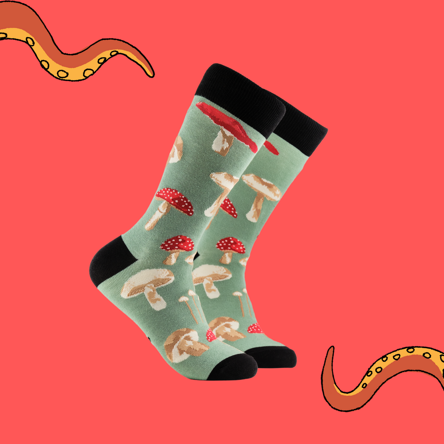 A pair of socks depicting different species of mushroom. Green legs, black cuff, heel and toe.