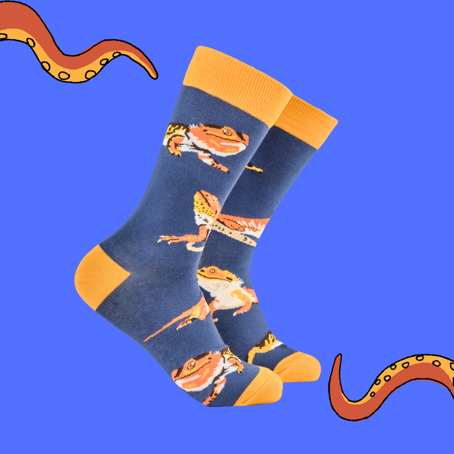 A pair of socks depicting bearded dragons. Blue legs, yellow heel, toe and cuff.
