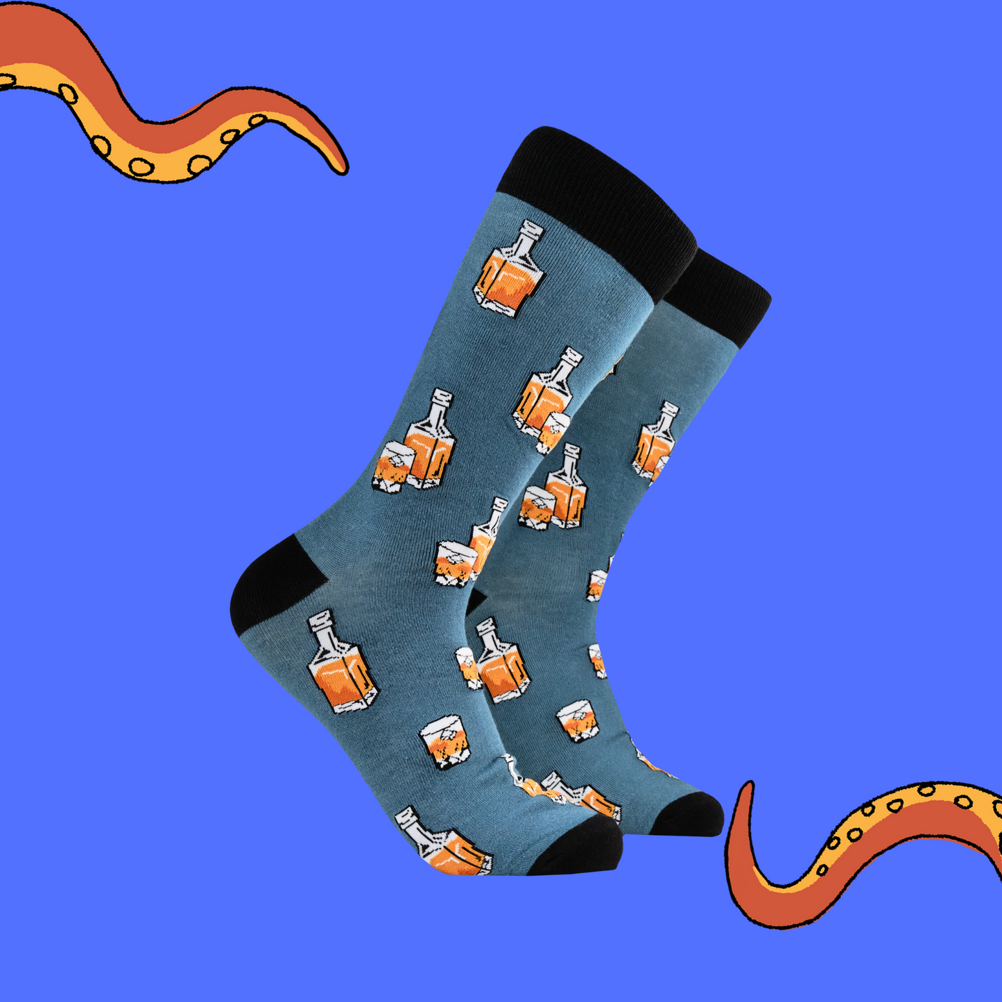 A pair of socks depicting whiskey in a glass and bottle. Blue legs, black heel, toe and cuff.