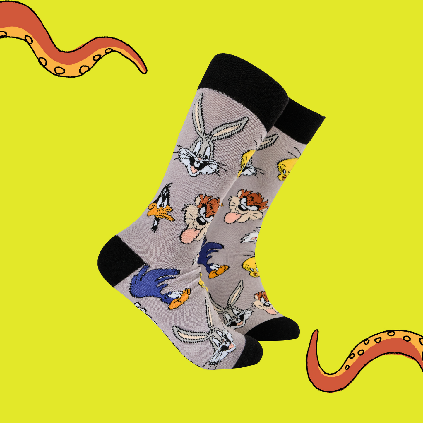A pair of socks featuring the famous looney tunes gang. Grey legs, black toe, heel and cuff.