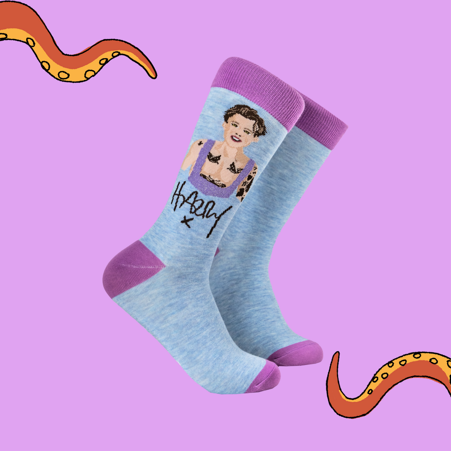 A pair of socks depicting Harry Styles. Blue legs, purple toe, heel and cuff.