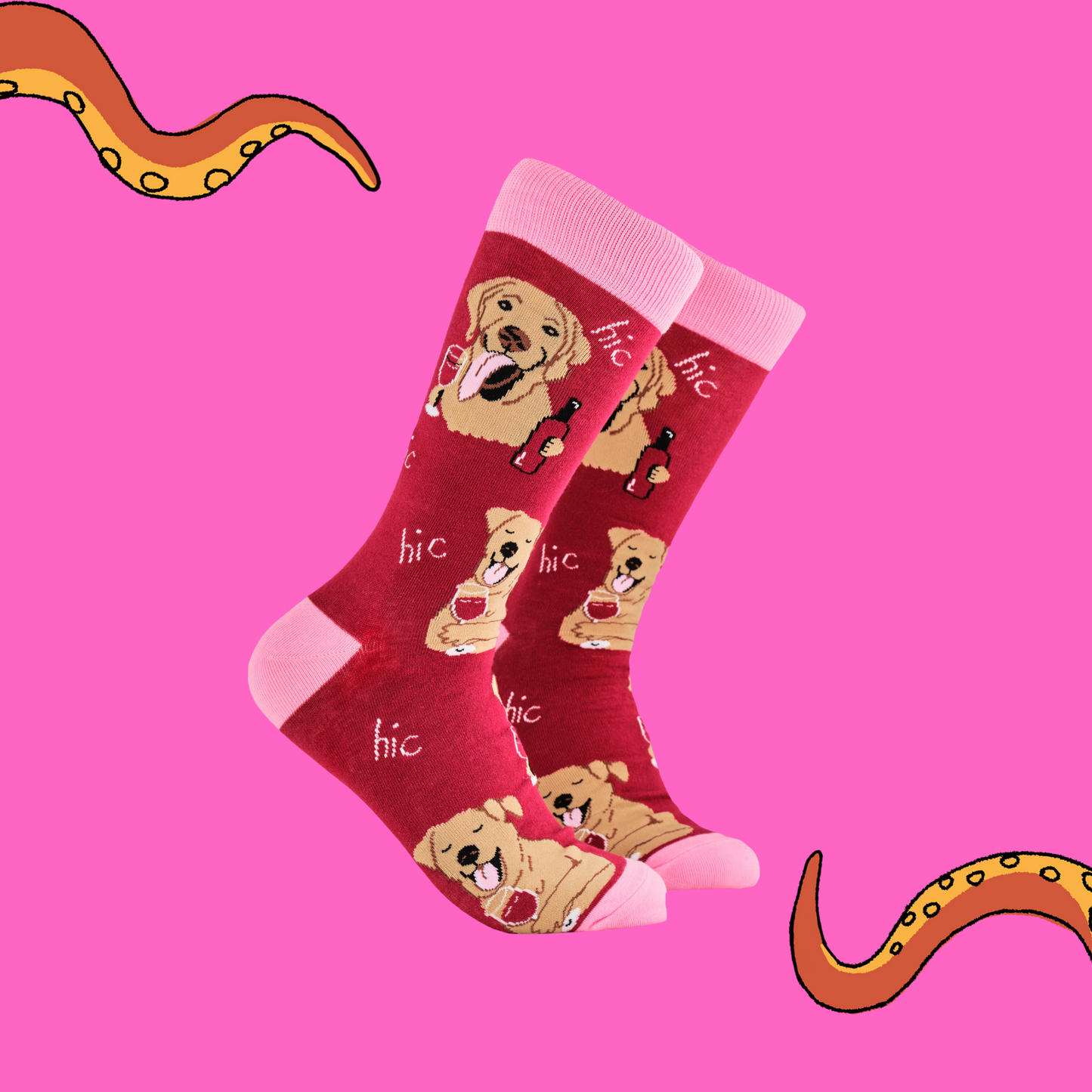 A pair of socks depicting labs drinking wine. Red legs, light pink cuff, heel and toe.