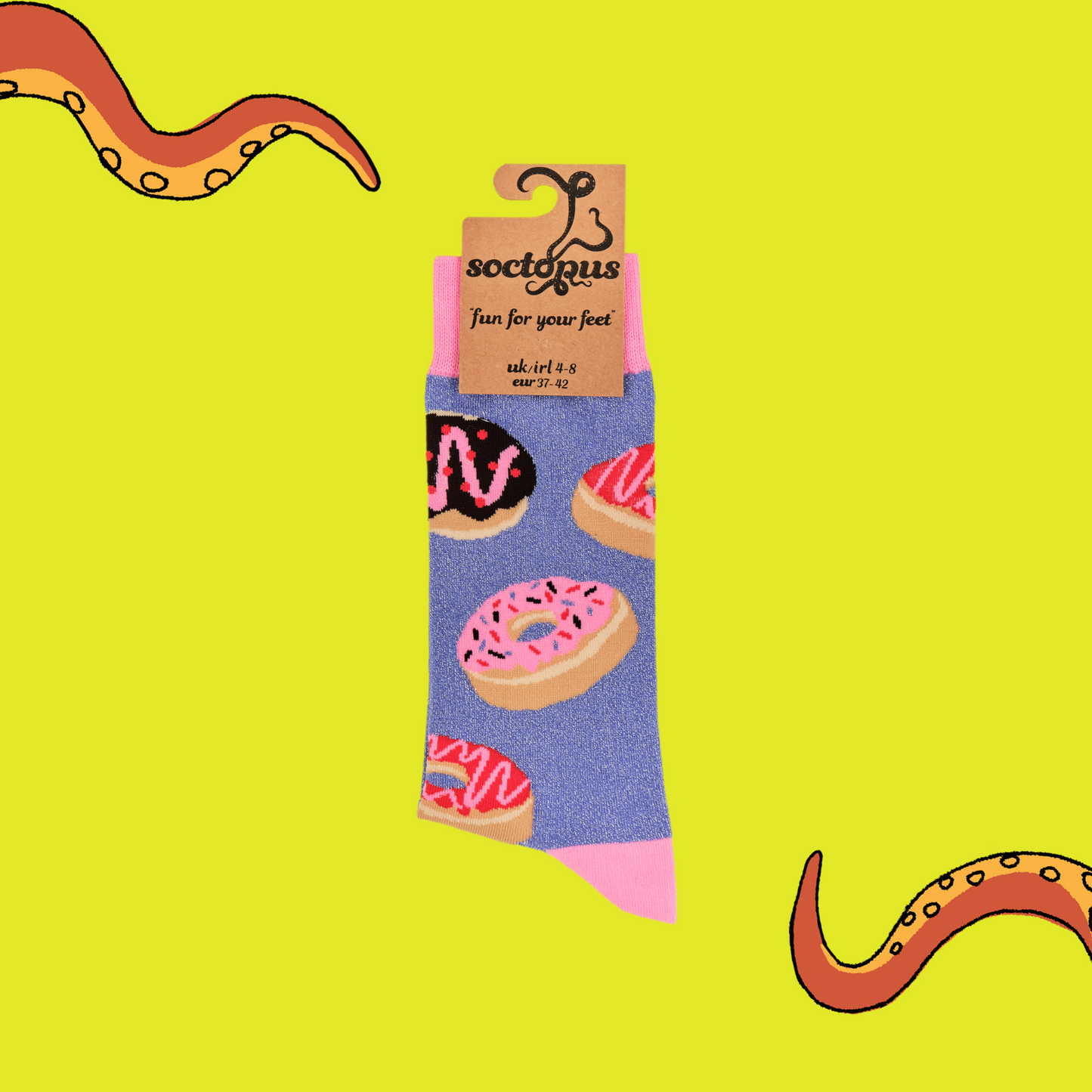 A pair of socks depicting iced doughnuts. Light purple legs, pink cuff, heel and toe. In Soctopus Packaging.