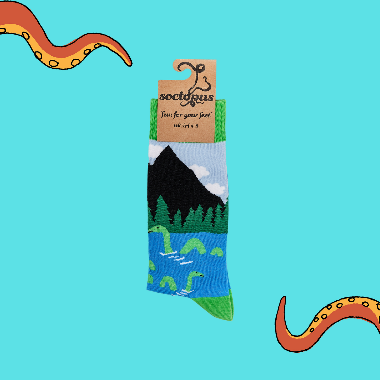 A pair of socks depicting the loch ness monster. Blue legs, green cuff, heel and toe. In Soctopus Packaging.