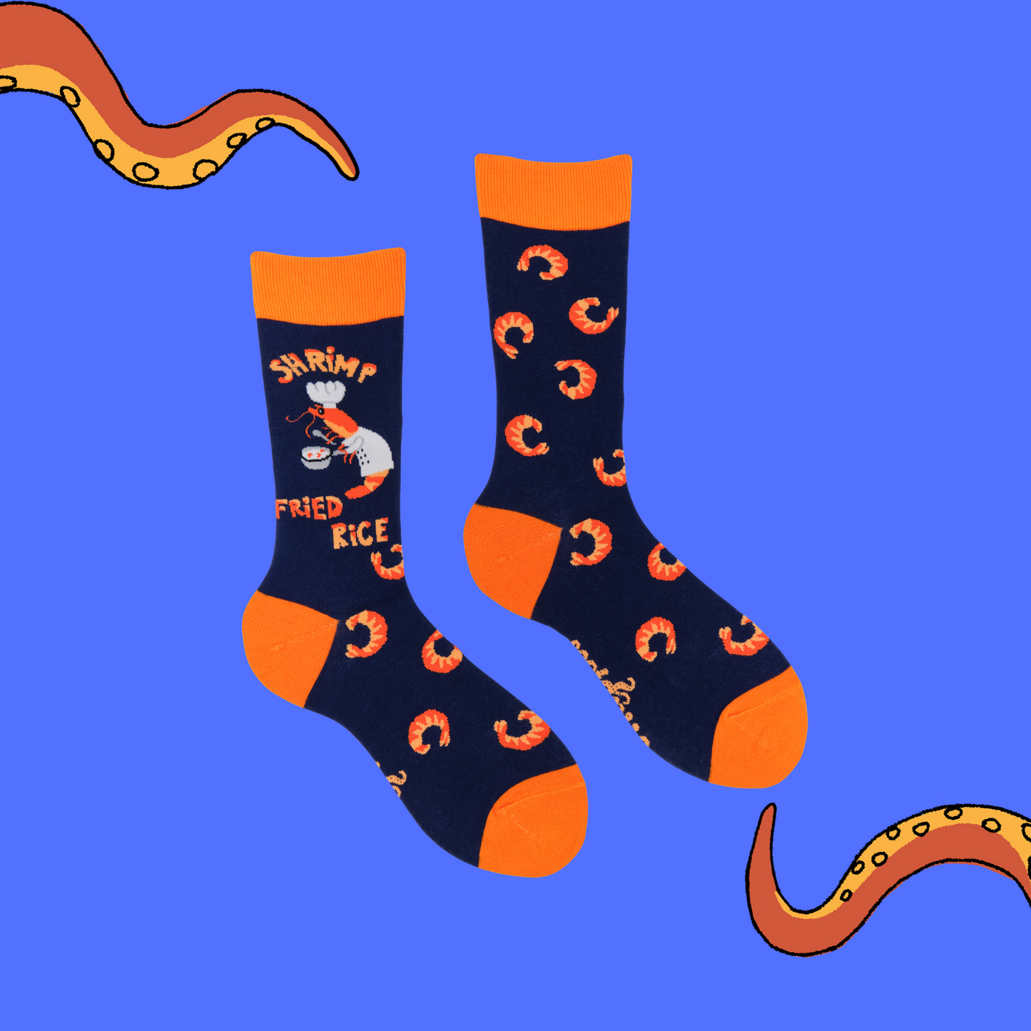 A pair of socks featuring a shrimp dressed as a chef. Dark blue legs, orange heel, toe and cuff.