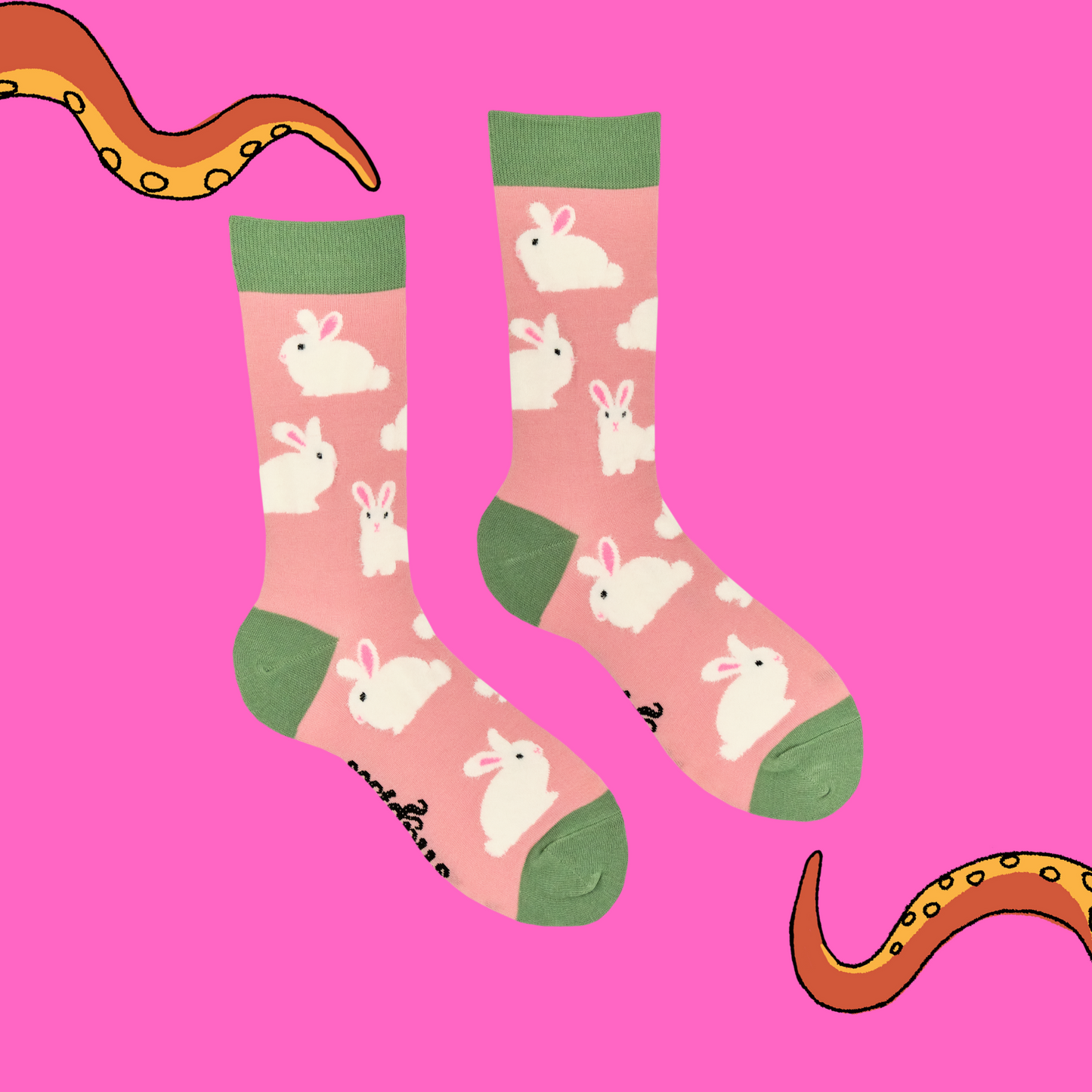 A pair of socks that feature fluffy bunnies. Pink legs, green, heel, toe and cuff.