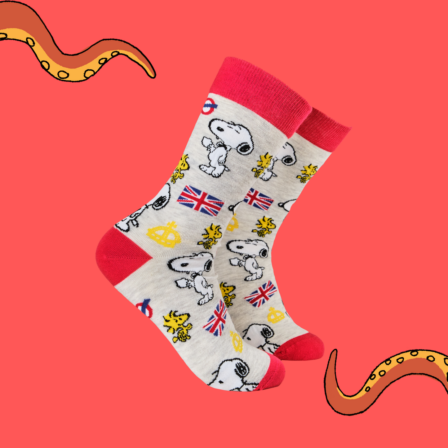 A pair of socks depicting Snoopy and Woodstock with a London motif. Grey legs, red cuff, toe and heel.