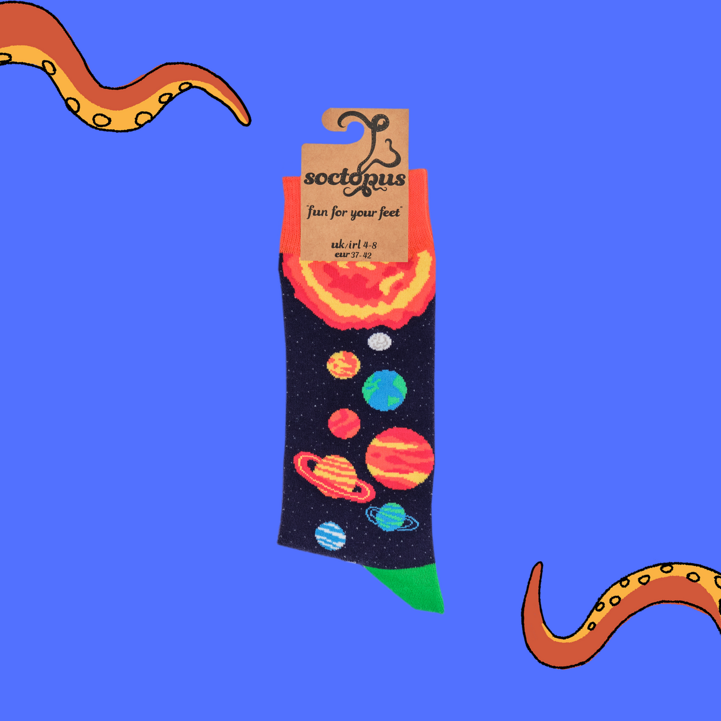 A pair of socks depicting planets and stars. Purple legs, orange cuff, green heel and toe. In Soctopus Packaging.