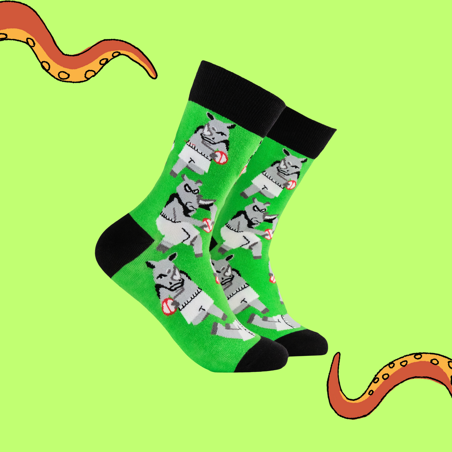 A pair of socks featuring rhinos playing rugby. Green legs, black heel, toe and cuff.