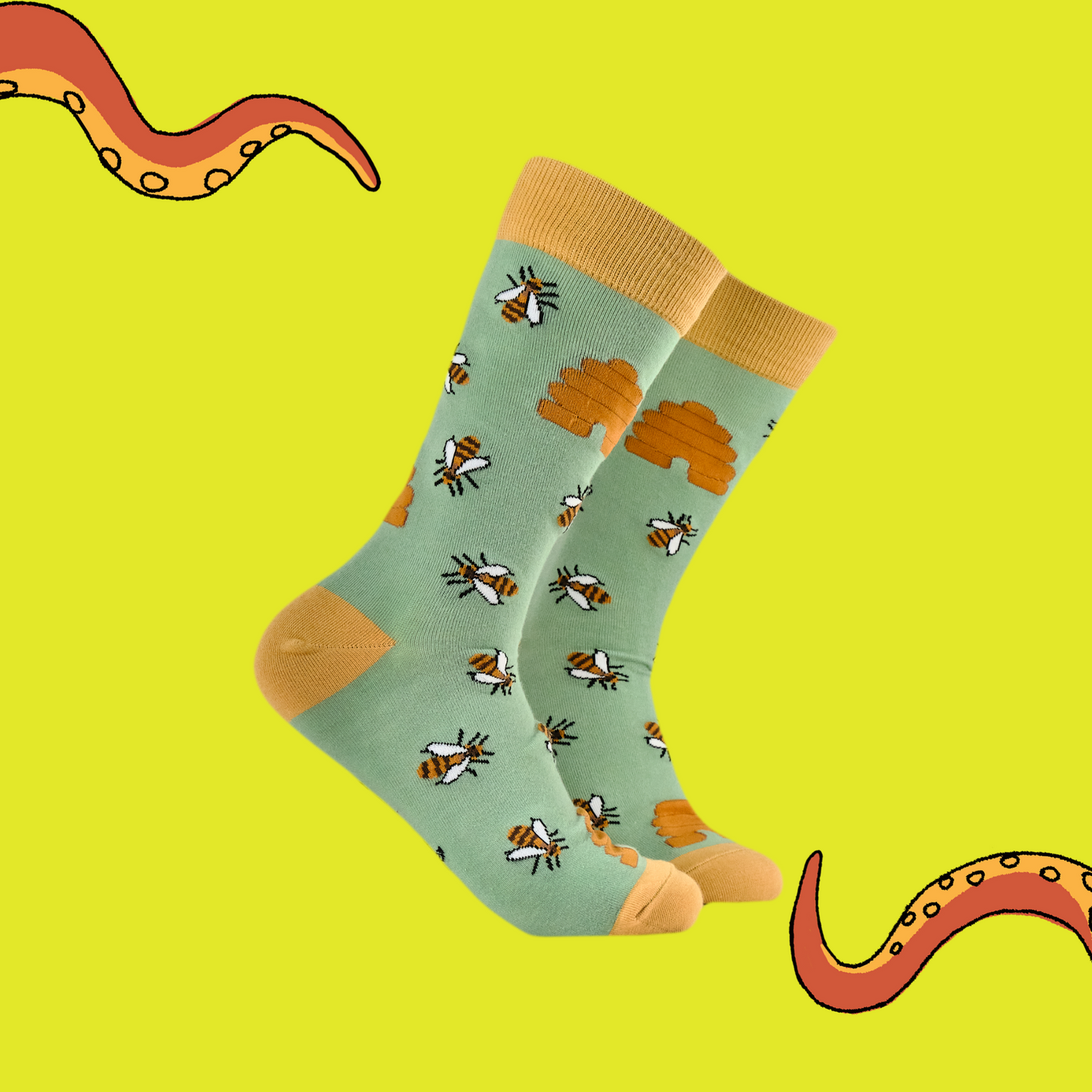 A pair of socks featuring honey bees. Green legs, yellow heel, toe and cuff.