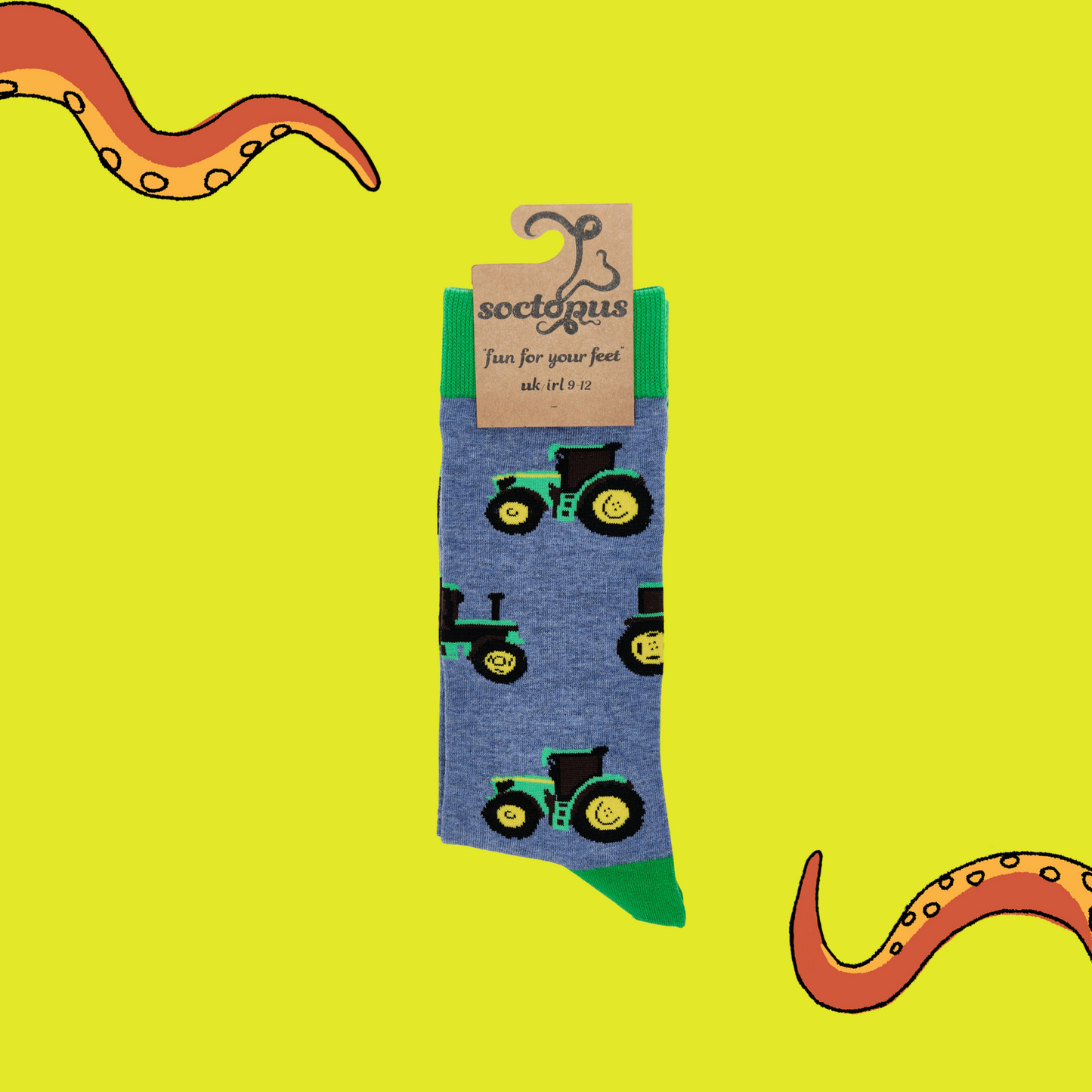 A pair of socks depicting green tractors. Blue legs, green cuff, heel and toe. In Soctopus Packaging.