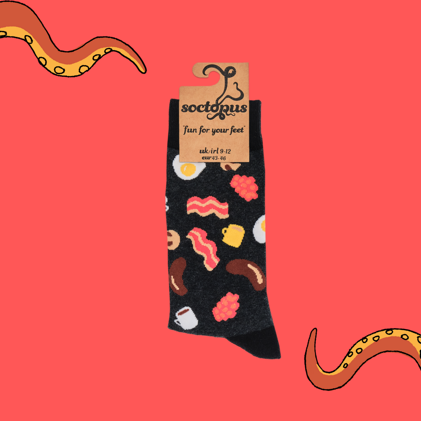 A pair of socks depicting English breakfast ingredients. Grey legs, black cuff, heel and toe. In Soctopus Packaging.