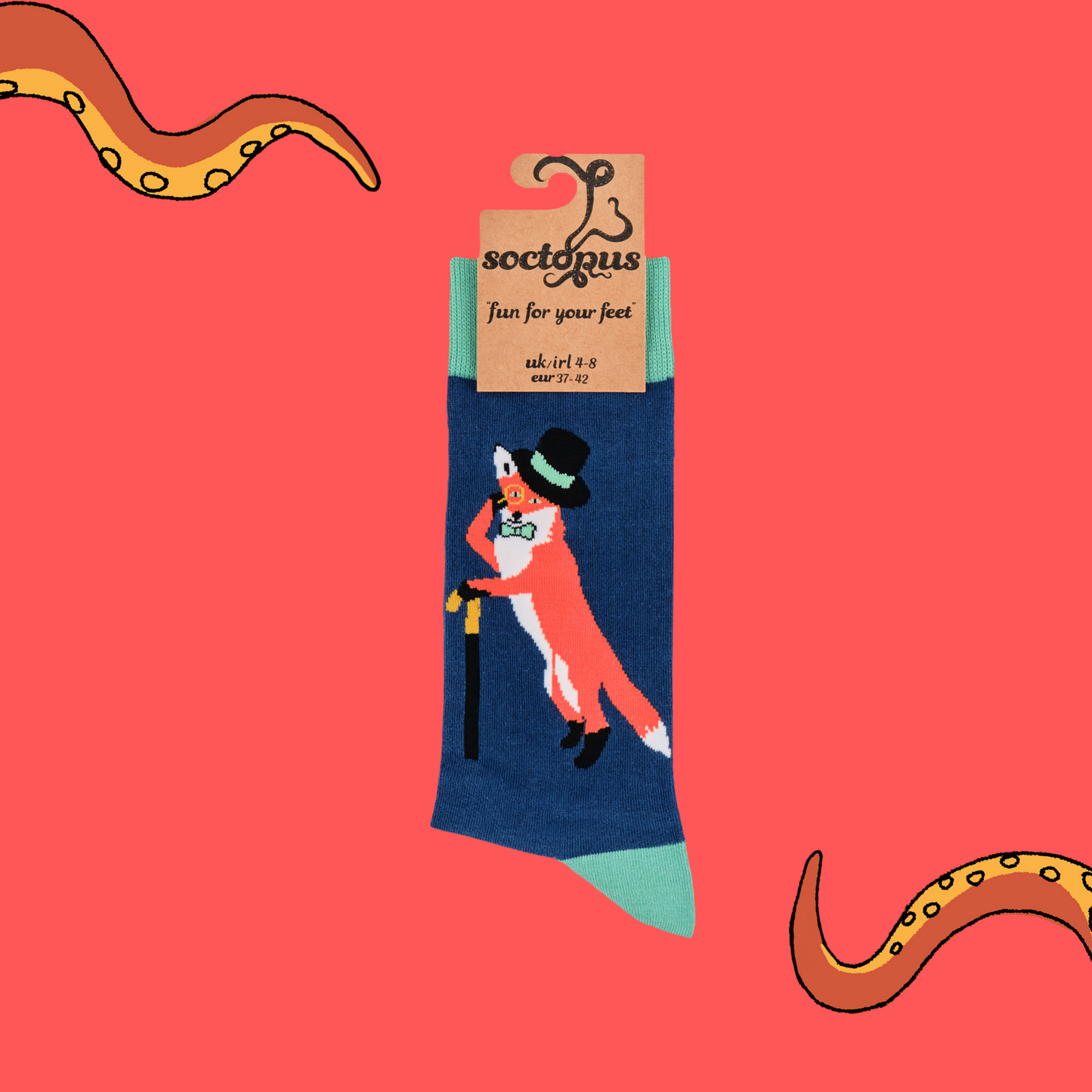 A pair of socks depicting a fox in a top hat and monocle. Blue legs, green cuff, heel and toe. In Soctopus Packaging.