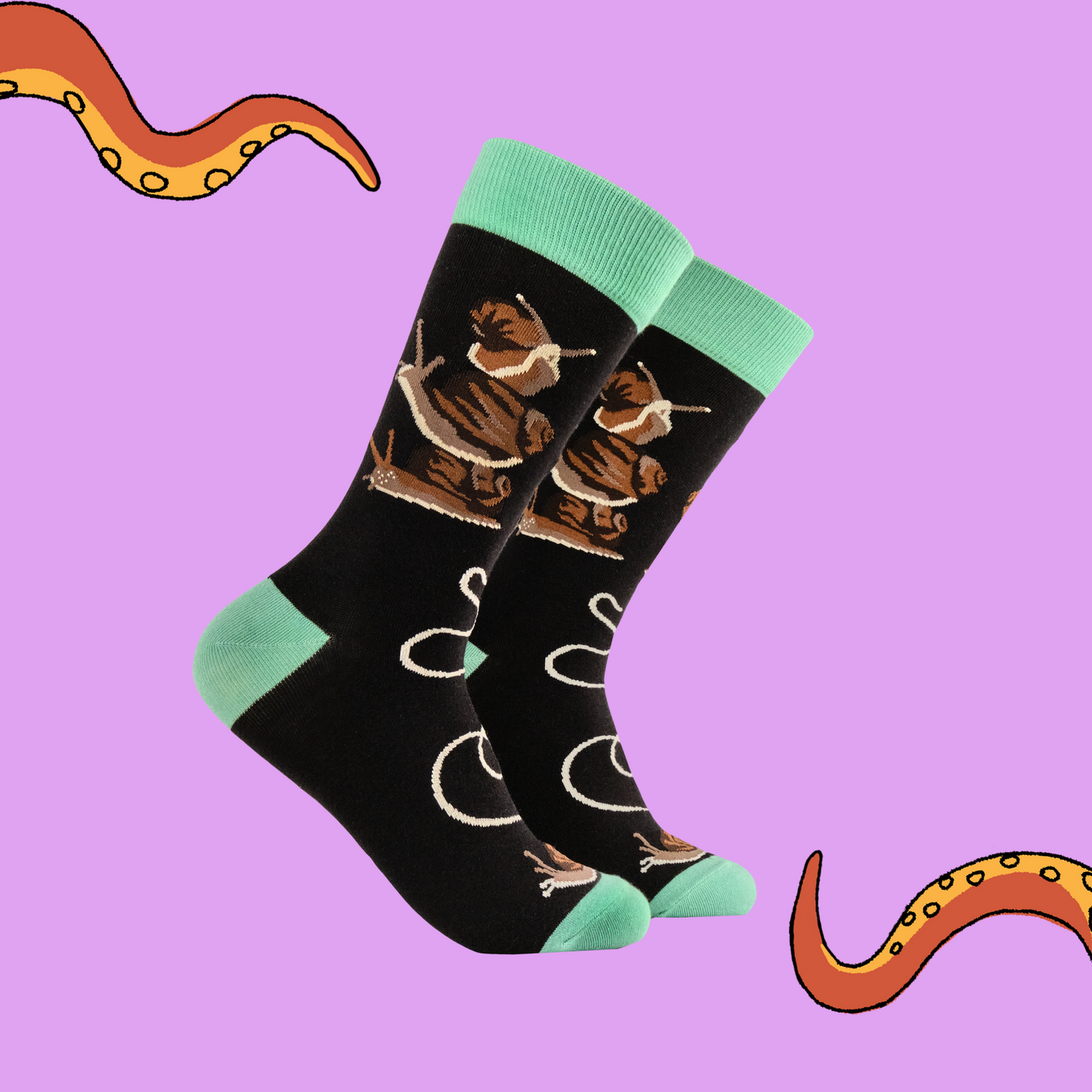 A pair of socks depicting snails. Black legs, green heel, toe and cuff.