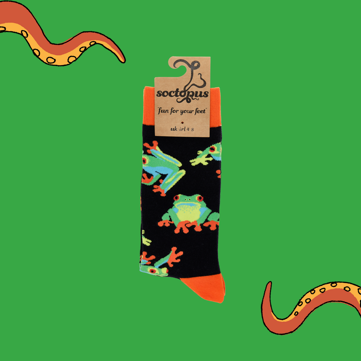 A pair of socks depicting tree frogs. Black legs, orange cuff, heel and toe. In Soctopus Packaging.