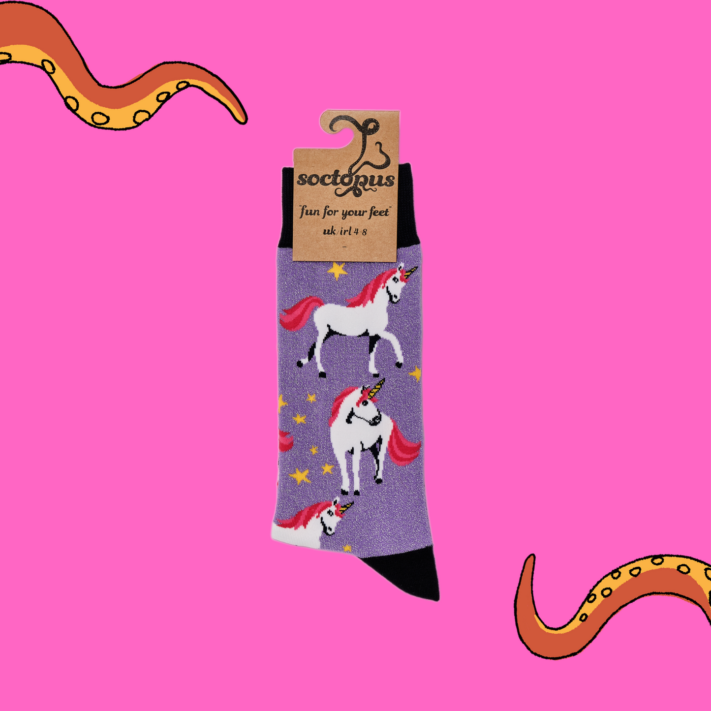 A pair of socks depicting unicorns. Glittery purple legs, black cuff, heel and toe. In Soctopus Packaging.