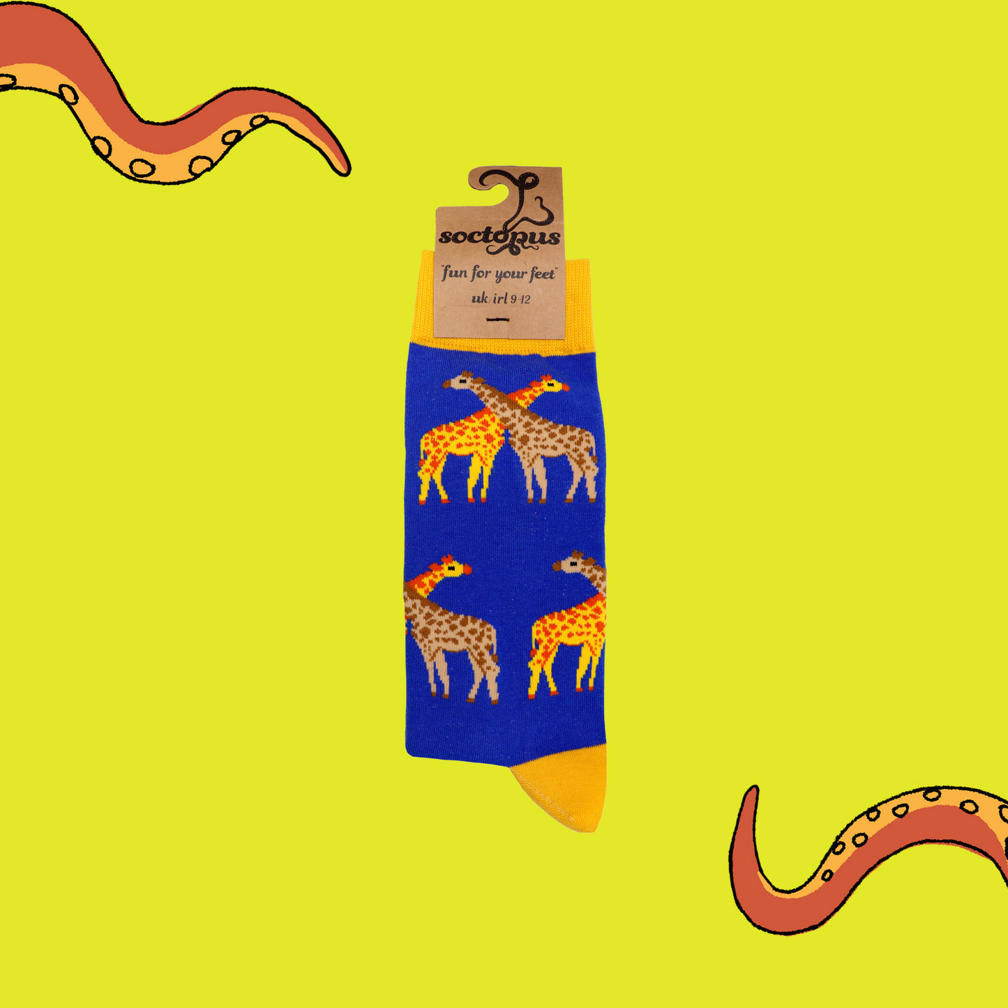 A pair of socks depicting giraffes. Royal blue legs, yellow cuff, heel and toe. In Soctopus Packaging.