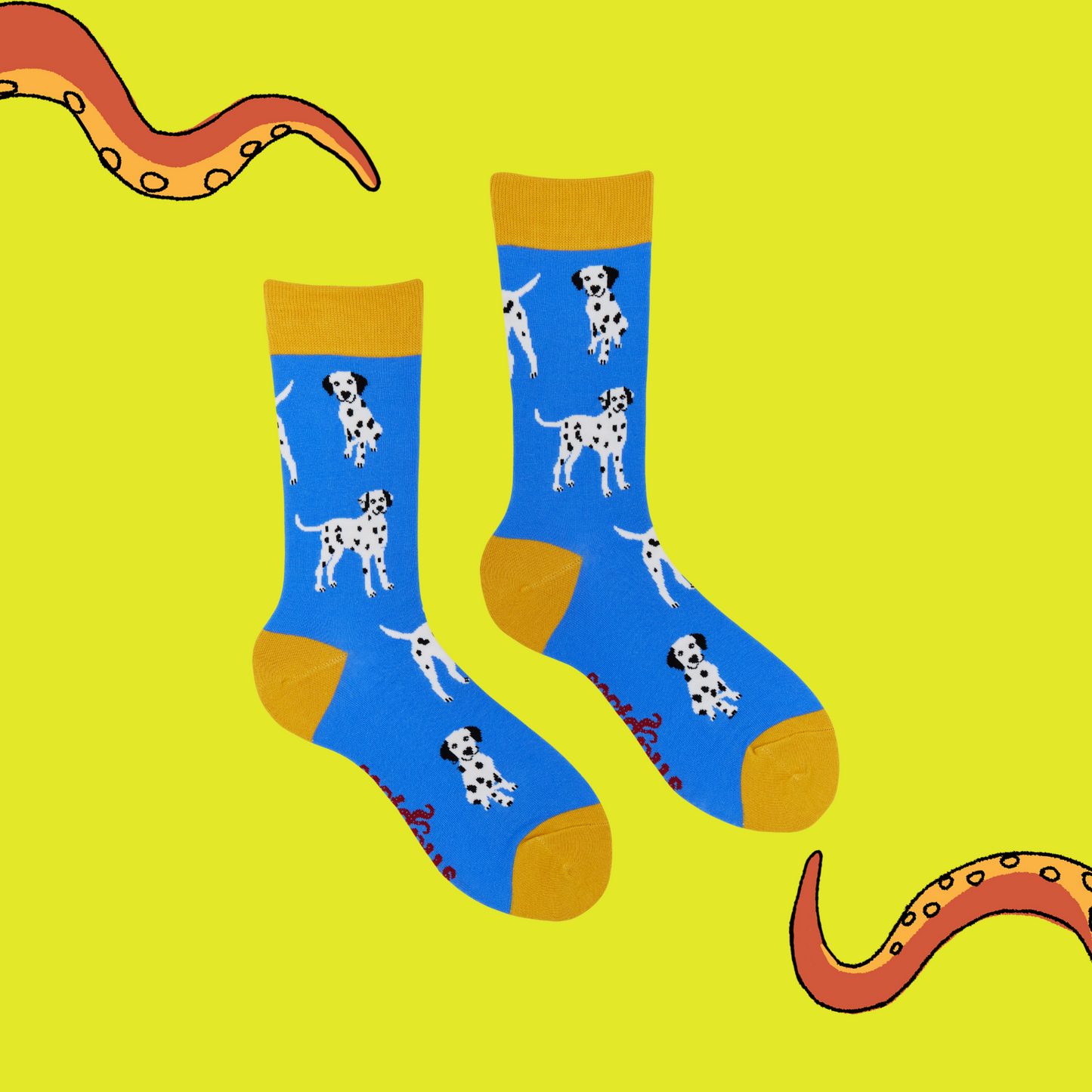 A pair of socks with a dalmatian motif. Blue legs, yellow heel, toe and cuff.