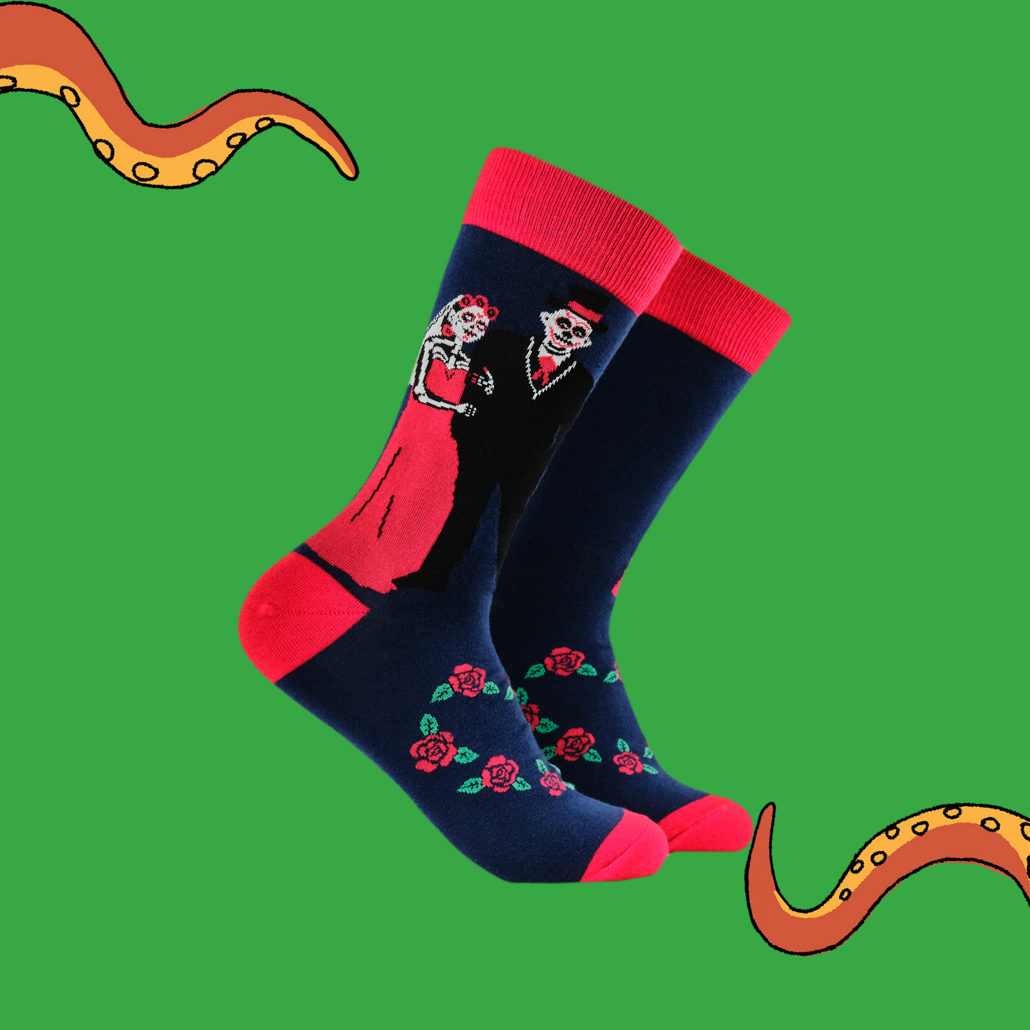 A pair of socks with a day of the dead motif. Dark blue legs, red heel, toe and cuff.