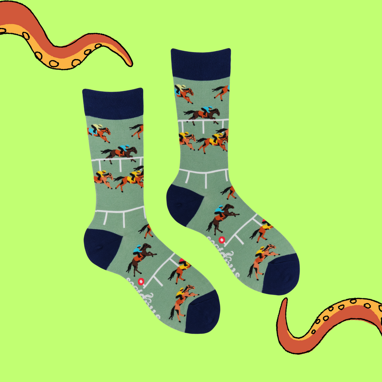 A pair of socks depicting horse racing. Green legs, black cuff, heel and toe.