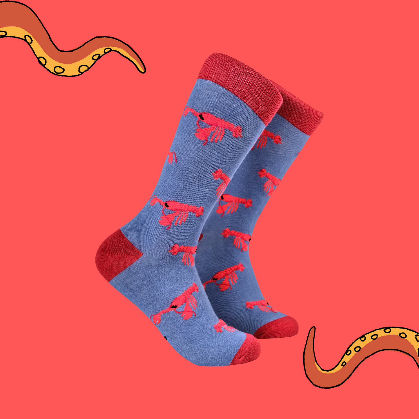 A pair of socks with a lobster motif. Blue legs, red heel, toe and cuff.