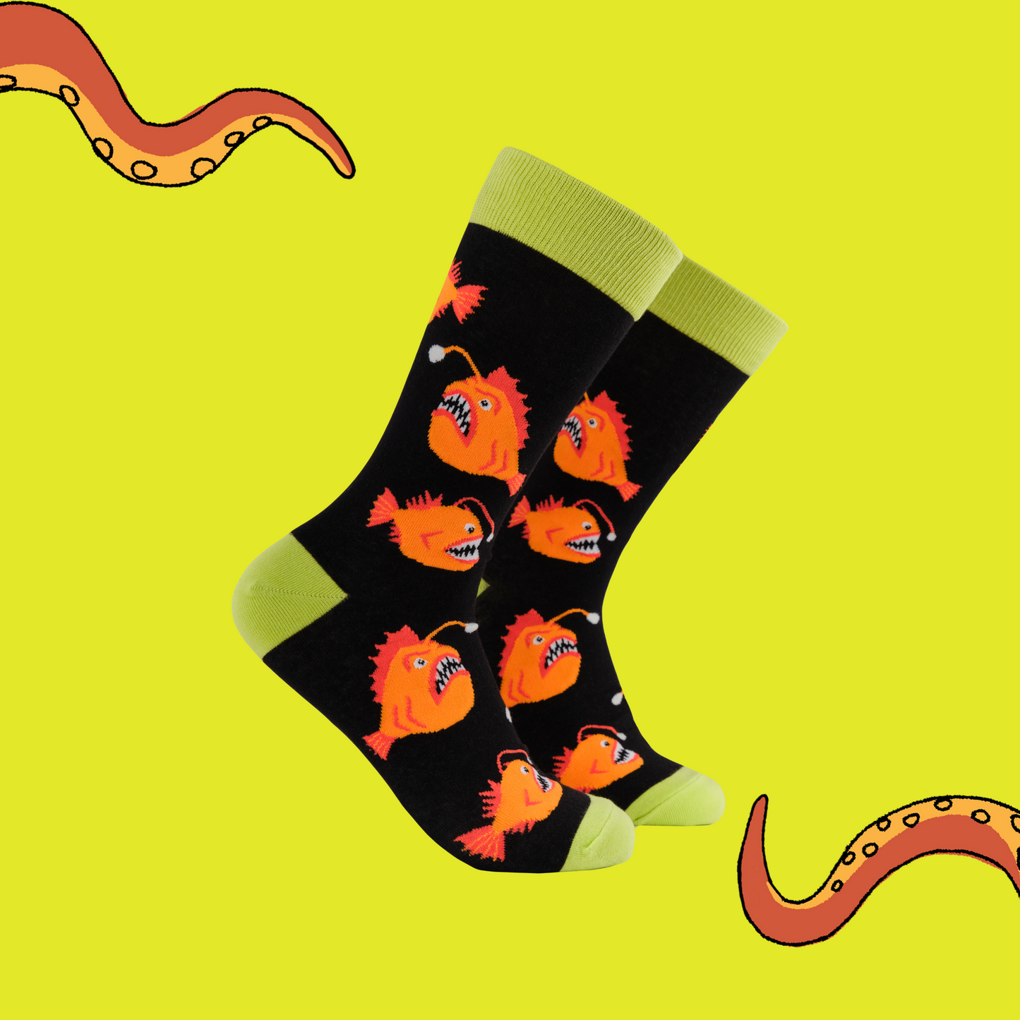 A pair of socks with an angler fish motif. Black legs, yellow heel toe and cuff