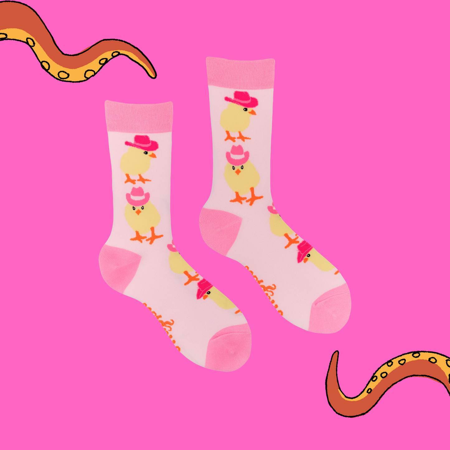 A pair of socks with a chick in cowboy hats motif. Light pink legs, dark pink heel, toe and cuff.