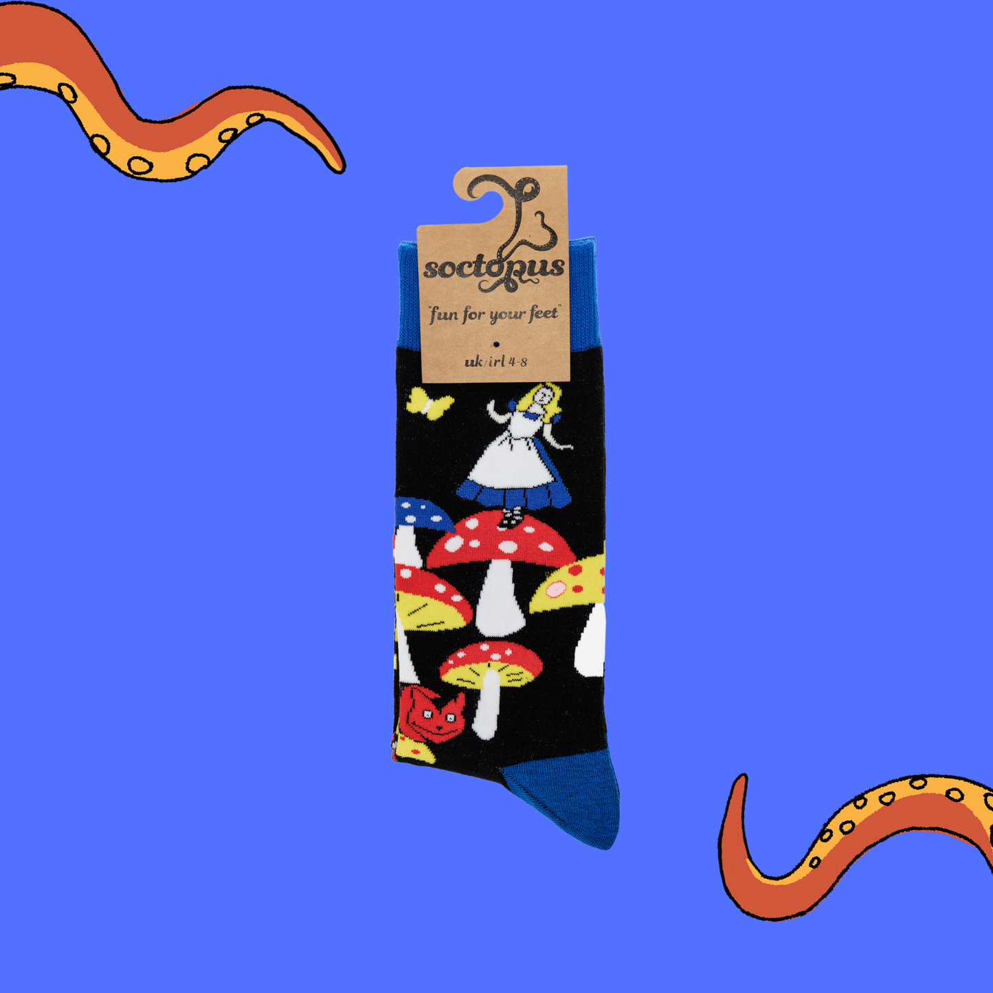 A pair of socks depicting Alice in wonderland and toadstools. Black legs, royal blue cuff, heel and toe. In Soctopus Packaging.