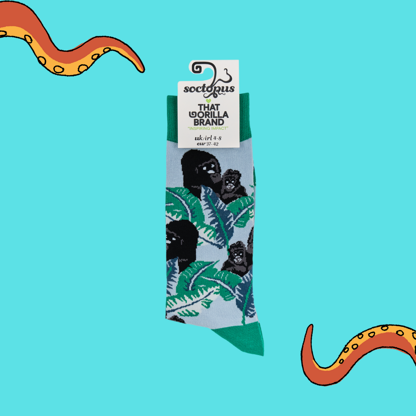 A pair of socks depicting gorillas in the forest. Green legs, green cuff, heel and toe. In Soctopus Packaging.