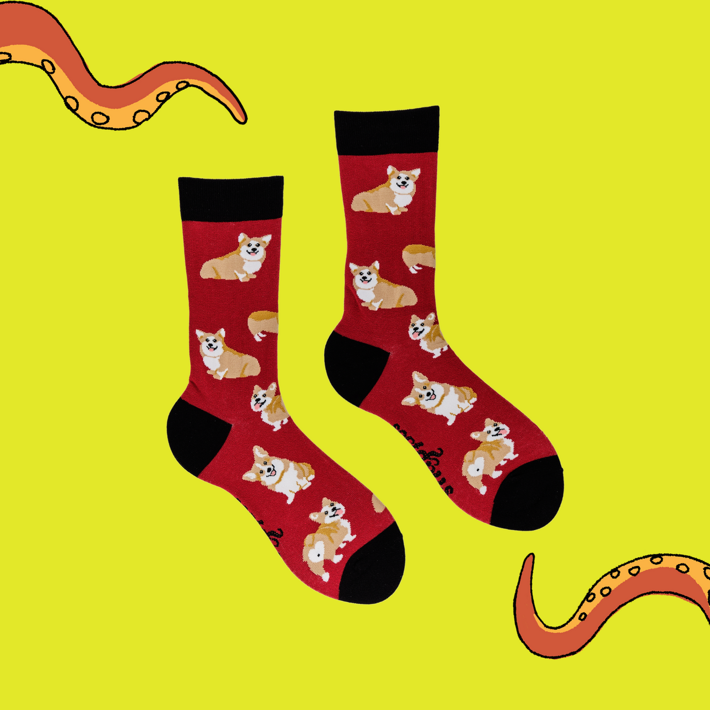 A pair of socks depicting corgis. Red legs, black cuff, heel and toe.